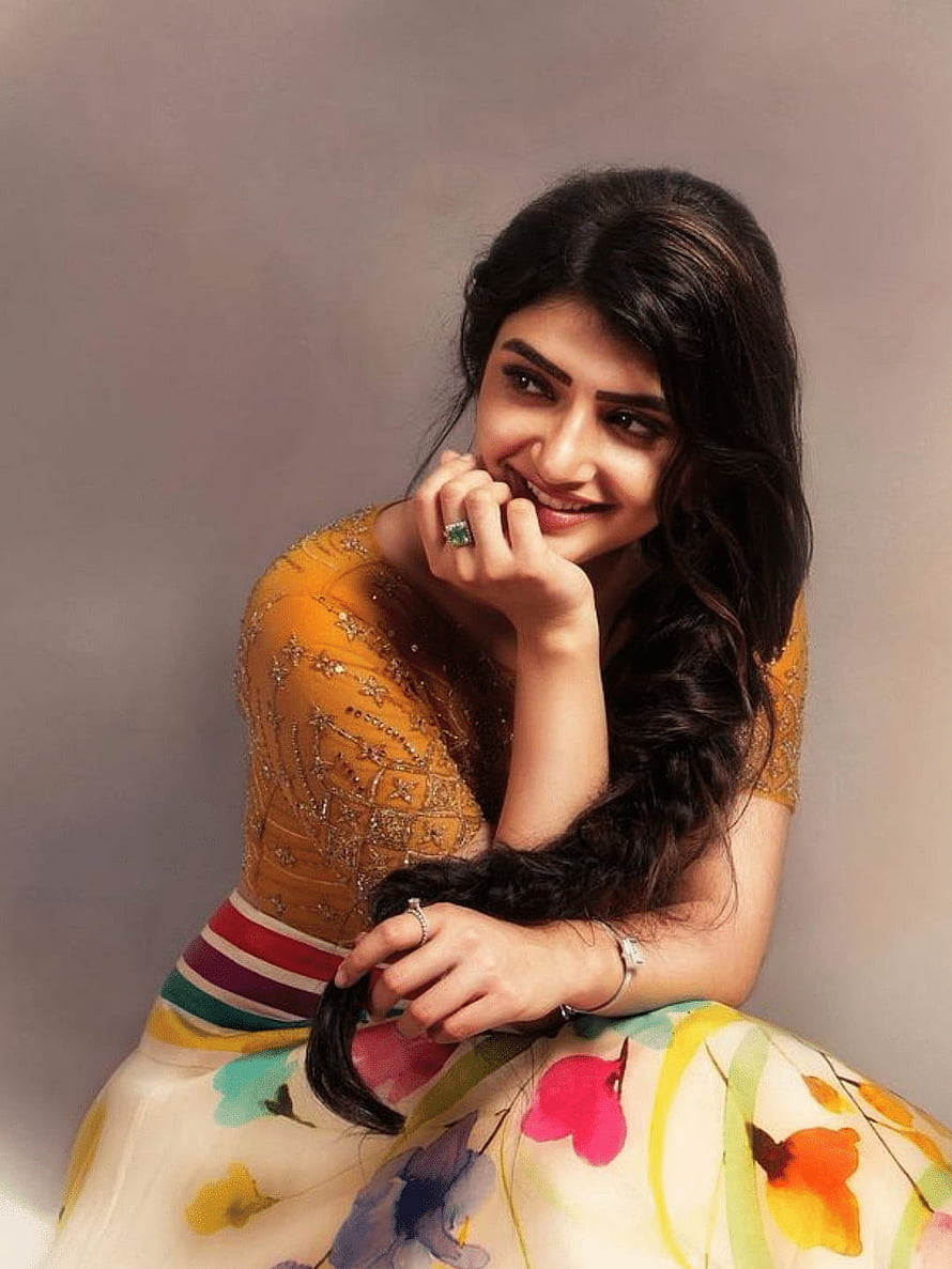 Sree Leela in a mustard embroidered blouse and floral skirt with long dark hair HD phone wallpaper