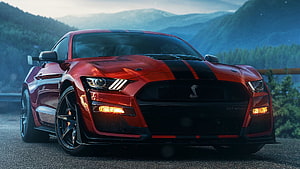 Red Ford Mustang Shelby GT500 with Black Racing Stripes on Mountain Road HD wallpaper