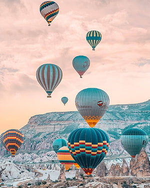 Colorful Hot Air Balloons Floating Over Cappadocia Rock Formations at Sunrise HD phone wallpaper