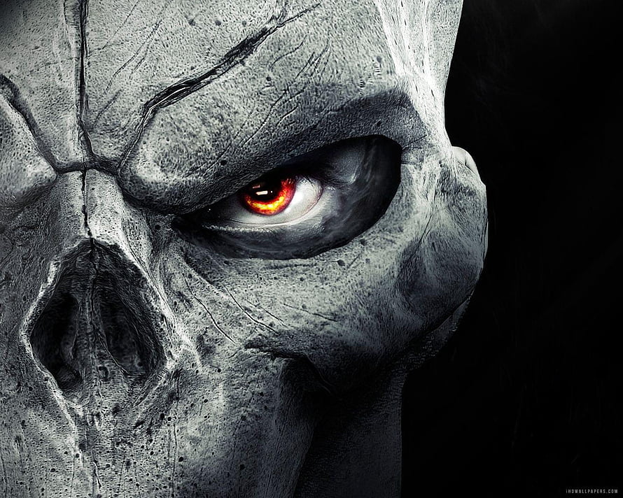 Close-Up of a Cracked Stone Skull with a Glowing Red Eye in Dark Horror Style HD wallpaper