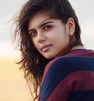 Kalyani Priyadarshan Portrait in Striped Knit Sweater with Soft Golden Background HD phone wallpaper