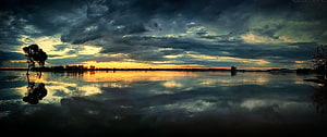 Dramatic Everglades Sunset with Stormy Clouds and Water Reflections HD wallpaper