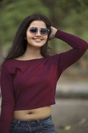 Anupama Parameswaran smiling in a maroon crop top and sunglasses outdoors HD phone wallpaper