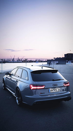 Audi RS6 Avant Rear View at Dusk with Harbor and Cranes in Background HD phone wallpaper