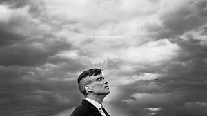 Thomas Shelby from Peaky Blinders Gazing Up at Stormy Clouds in Black and White HD wallpaper