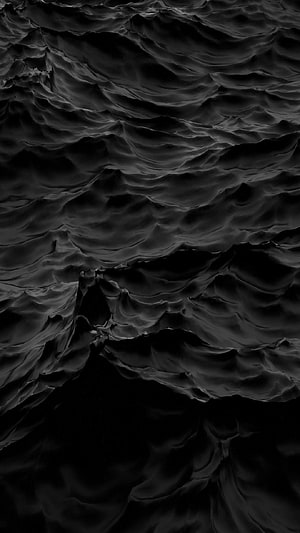 Dark rippling water surface with deep black waves and moody abstract texture HD phone wallpaper
