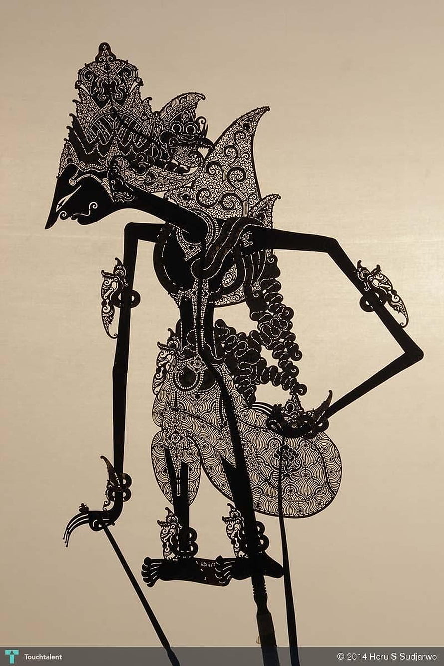 Intricate Black Wayang Kulit Shadow Puppet with Ornate Carved Details on Beige Background HD phone wallpaper