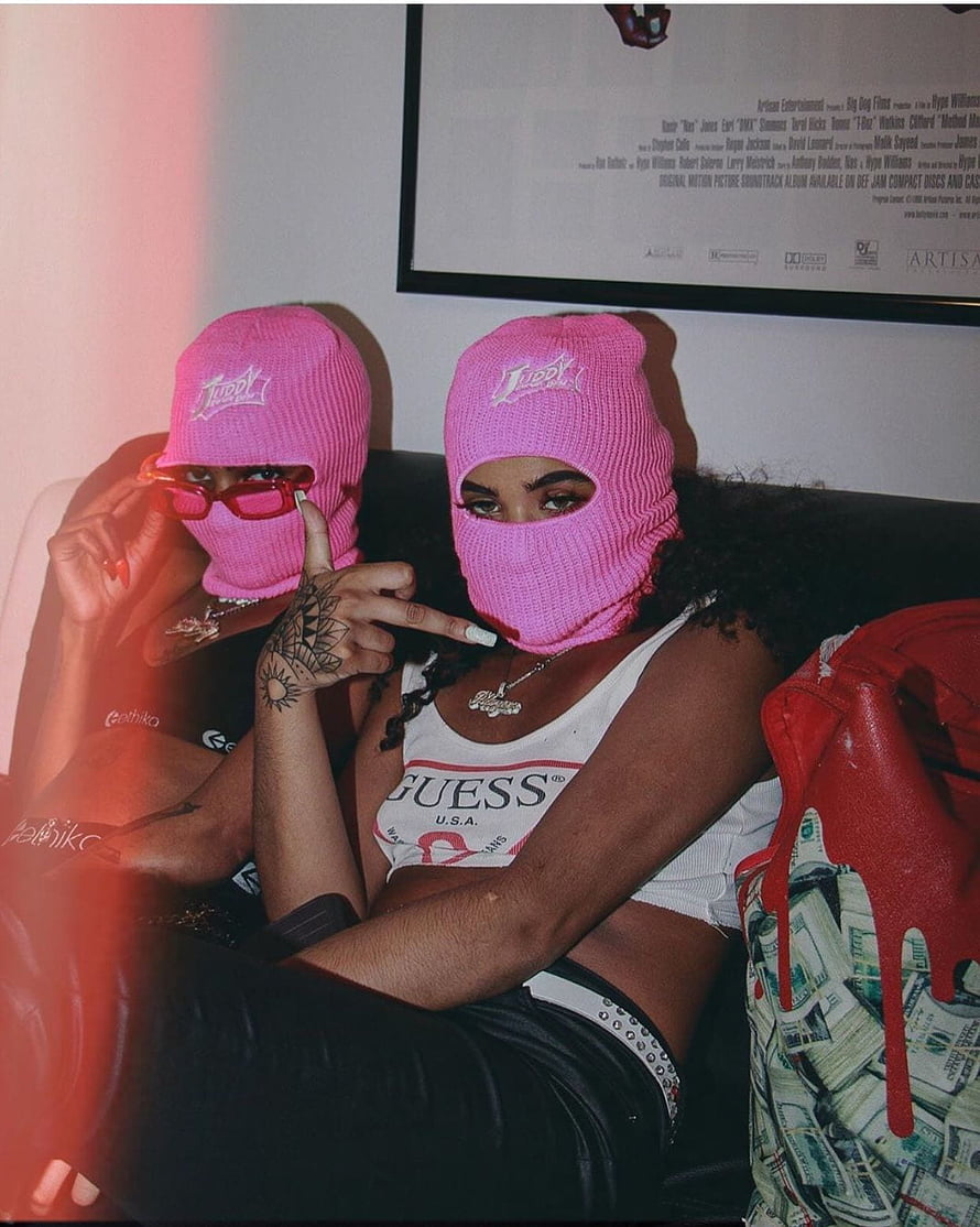 Two women in pink ski masks posing with red sunglasses and a Guess tank top HD phone wallpaper