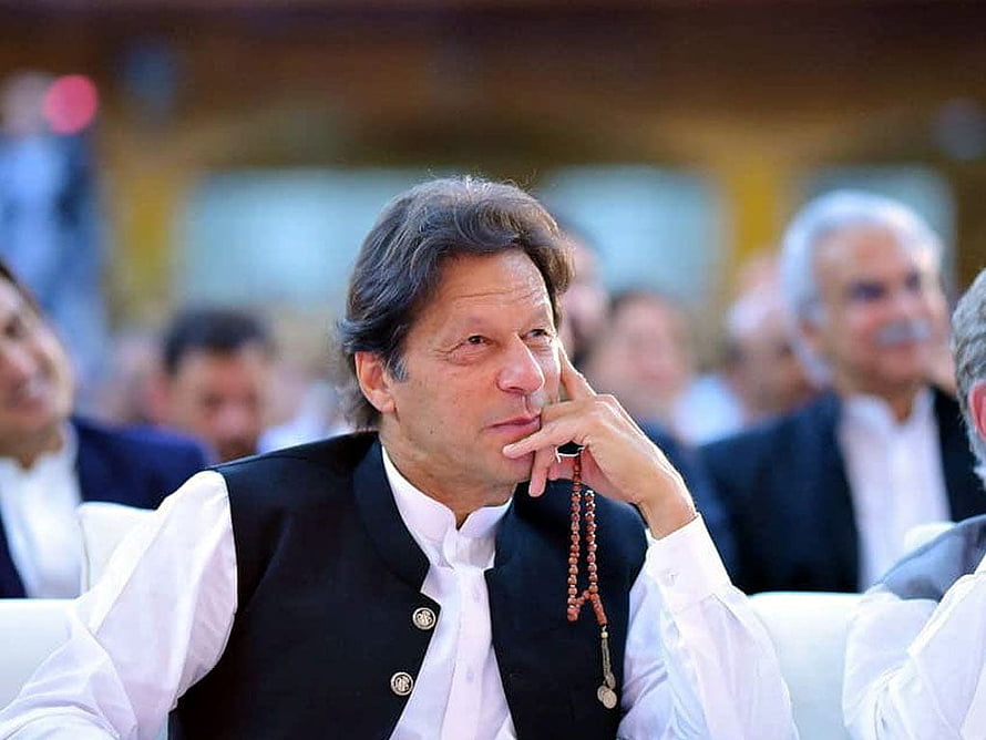Imran Khan in Contemplative Pose Wearing Traditional Black Waistcoat and Prayer Beads HD wallpaper