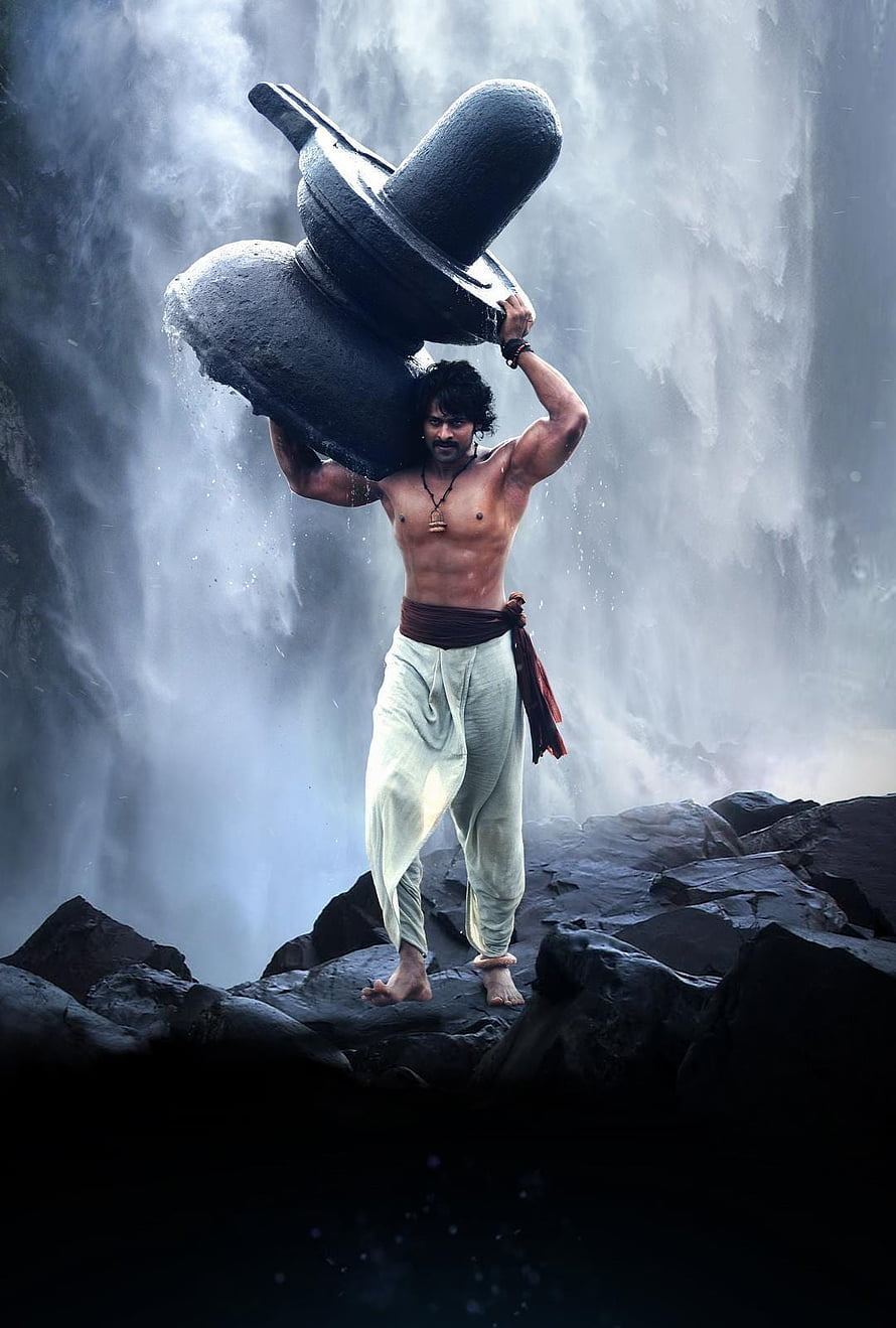 Bahubali Carrying Stone Grinder at Waterfall in Epic Fantasy Film Scene HD phone wallpaper