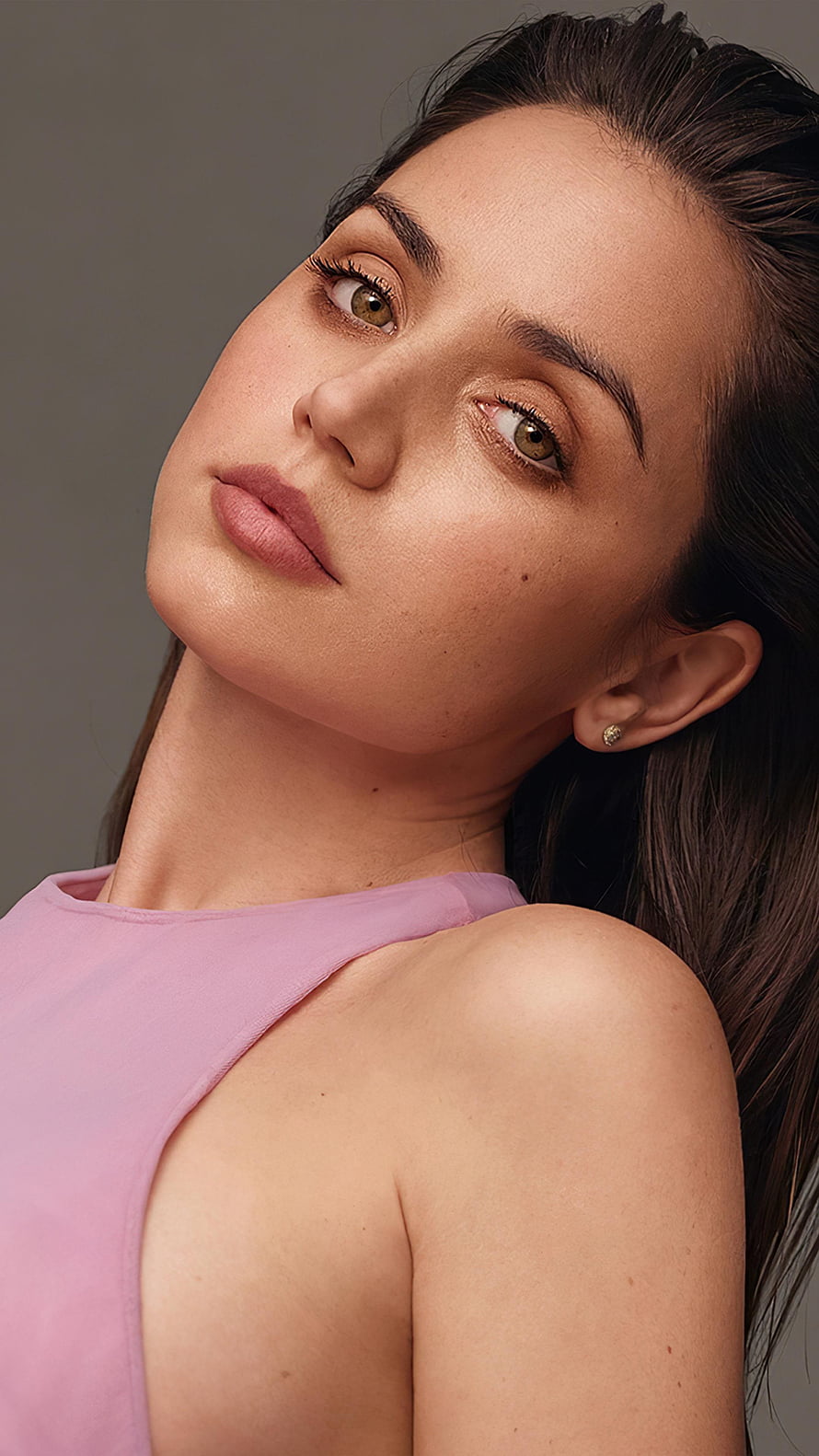Ana de Armas in a soft pink sleeveless top with natural makeup and a neutral studio backdrop HD phone wallpaper