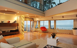 Spacious Modern Living Room With Ocean View And Warm Wood Flooring HD wallpaper