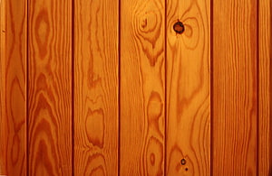 Warm Honey-Toned Pine Plank Wall with Natural Grain Patterns and Knots HD wallpaper
