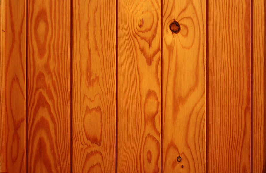 Warm Honey-Toned Pine Plank Wall with Natural Grain Patterns and Knots HD wallpaper