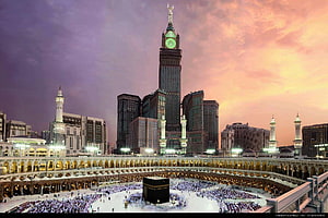 Makkah Clock Royal Tower and the Grand Mosque at sunset with pilgrims around the Kaaba HD wallpaper