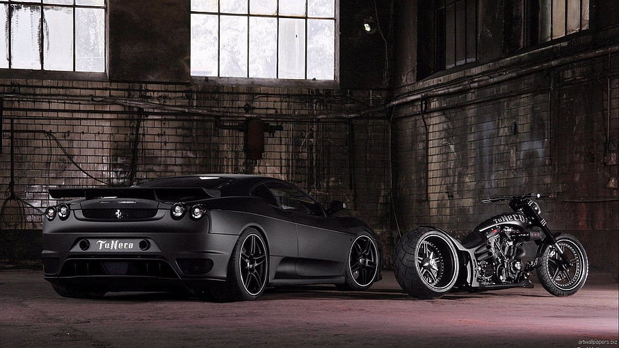 Matte Black Ferrari F430 and Custom Chopper Motorcycle in Industrial Warehouse HD wallpaper