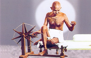 Mahatma Gandhi Spinning Cotton on a Traditional Charkha Wheel HD wallpaper