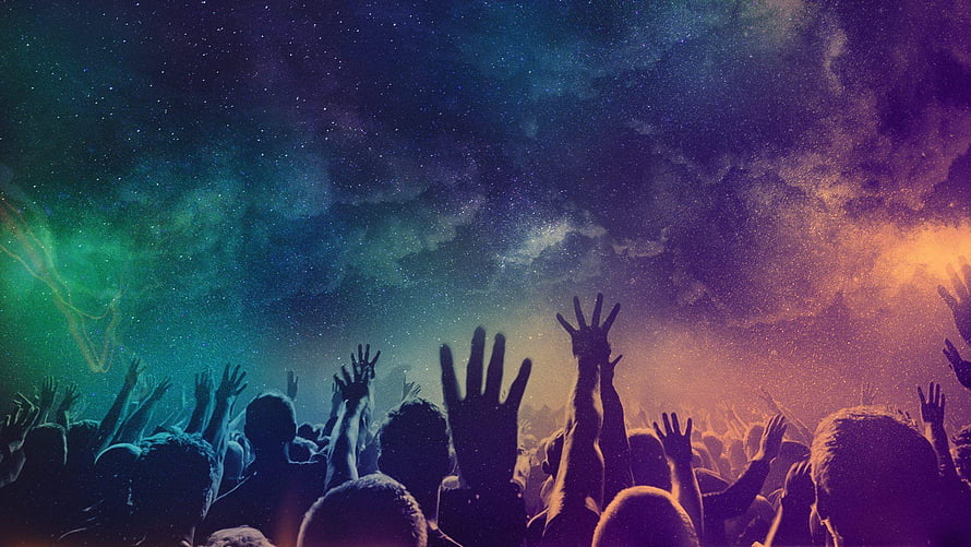 Silhouetted Worship Crowd With Raised Hands Under a Vibrant Starry Night Sky HD wallpaper