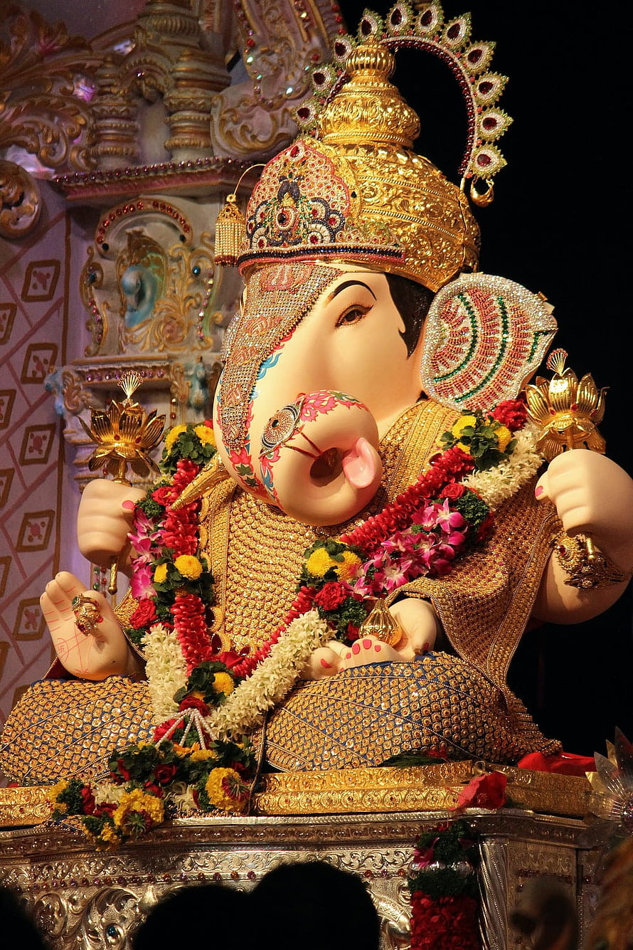 Dagdusheth Ganpati Murti Adorned With Gold Crown And Floral Garlands In Temple Setting HD phone wallpaper