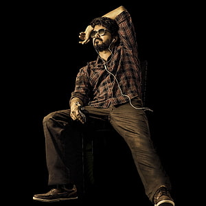 Thalapathy Vijay in a moody studio portrait wearing sunglasses and a plaid shirt HD phone wallpaper