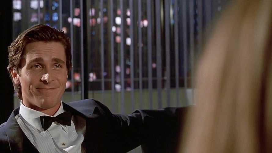 Patrick Bateman in a tuxedo with a city skyline at night from American Psycho HD wallpaper