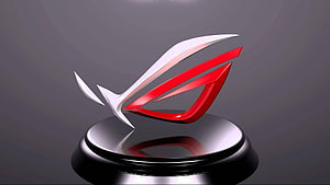Asus ROG 3D Logo Sculpture on Reflective Black Pedestal with Red and Silver Accents HD wallpaper