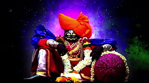 Jyotiba Deity in Traditional Attire with Orange Turban and Floral Garlands HD wallpaper