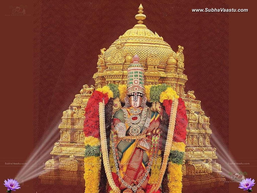 Perumal Deity Adorned in Gold Temple Architecture with Vibrant Floral Garlands HD wallpaper