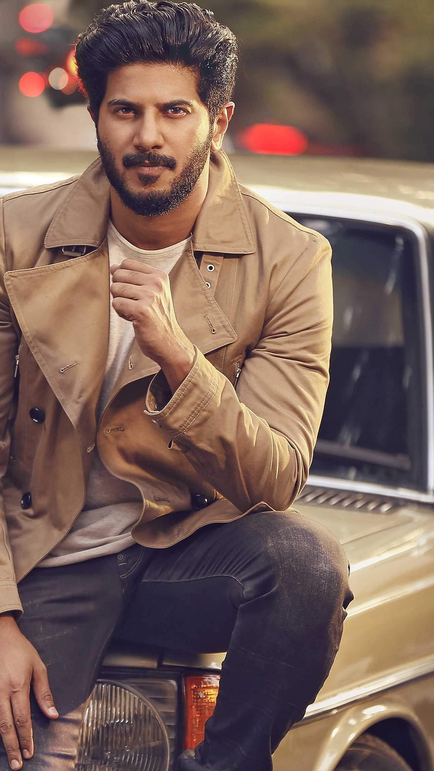 Dulquer Salmaan in Tan Jacket Sitting on Vintage Car Hood HD phone wallpaper