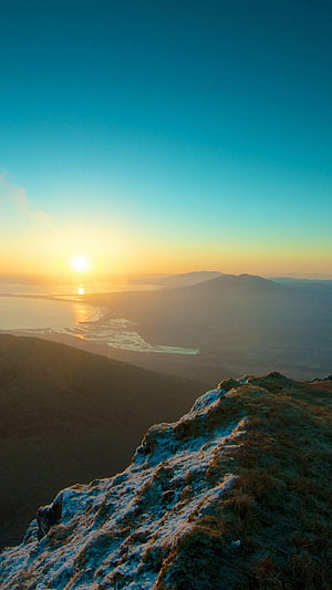 Sunrise Over Snowy Mountain Ridge and Coastal River Delta Landscape HD phone wallpaper