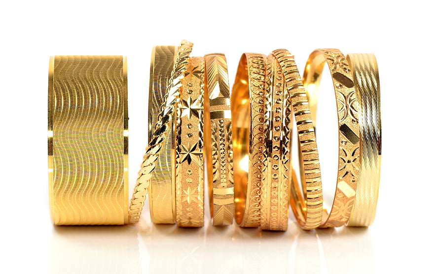 Assorted Gold Bangle Bracelets With Intricate Engraved Patterns And Textured Finishes HD wallpaper
