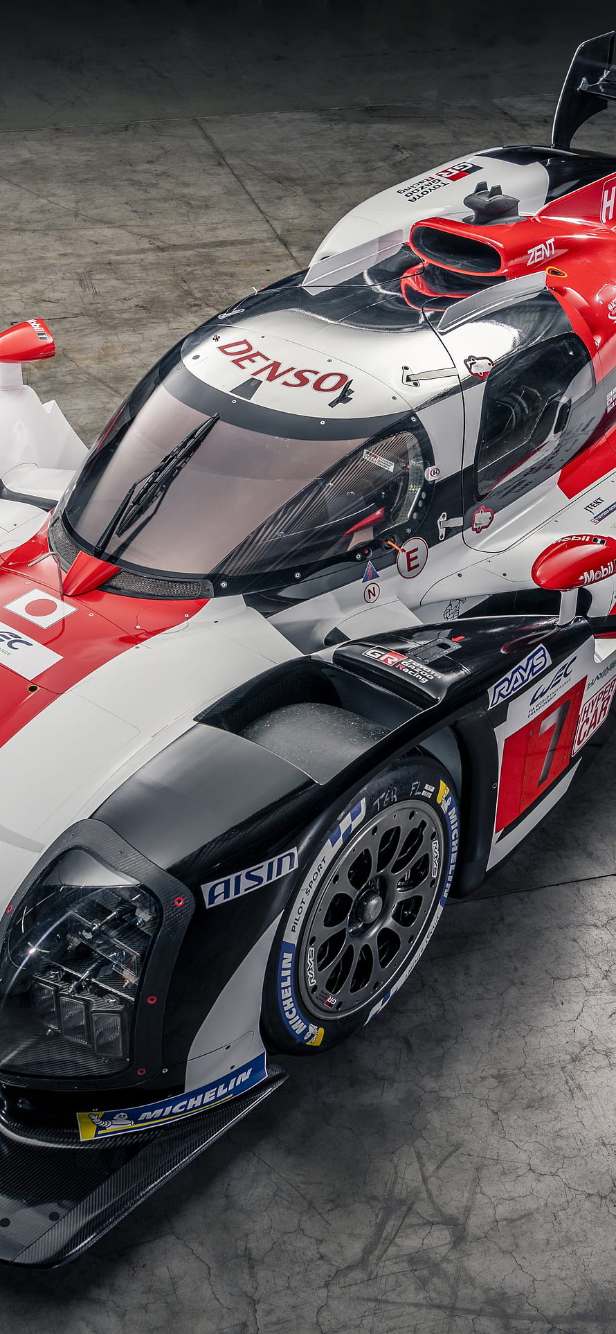 Toyota GR010 Hybrid Hypercar in Red and White Livery with Denso and Michelin Sponsorship HD phone wallpaper