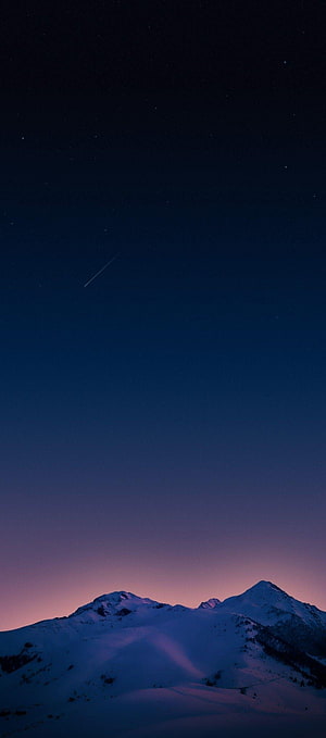 Snow-Capped Mountain Peaks Under a Starry Twilight Sky with a Shooting Star HD phone wallpaper