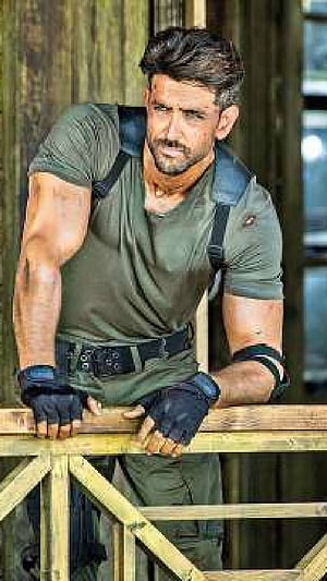 Hrithik Roshan in Tactical Combat Gear Leaning on Wooden Structure HD phone wallpaper