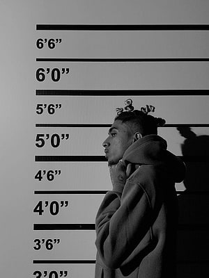 MC Stan Black and White Mugshot Portrait in Hoodie Against Height Chart HD phone wallpaper