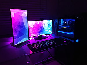 Triple Monitor Gaming PC Setup with RGB Backlighting and Mechanical Keyboard HD wallpaper