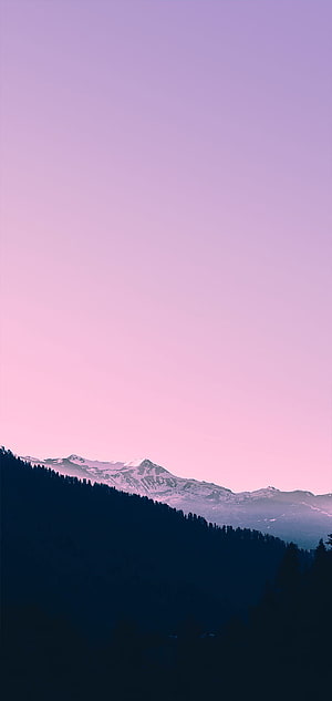 Serene Mountain Landscape with Snow-Capped Peaks Under a Soft Pink and Purple Sky HD phone wallpaper