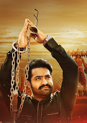 JR NTR Action Hero Poster with Chains and Sunglasses Against Golden Sky HD phone wallpaper