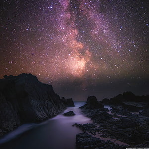 Milky Way Galaxy Arching Over Rocky Coastline at Night HD phone wallpaper