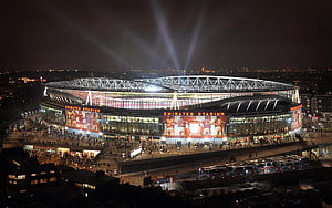 Emirates Stadium at Night with Arsenal Fans and Searchlights HD wallpaper