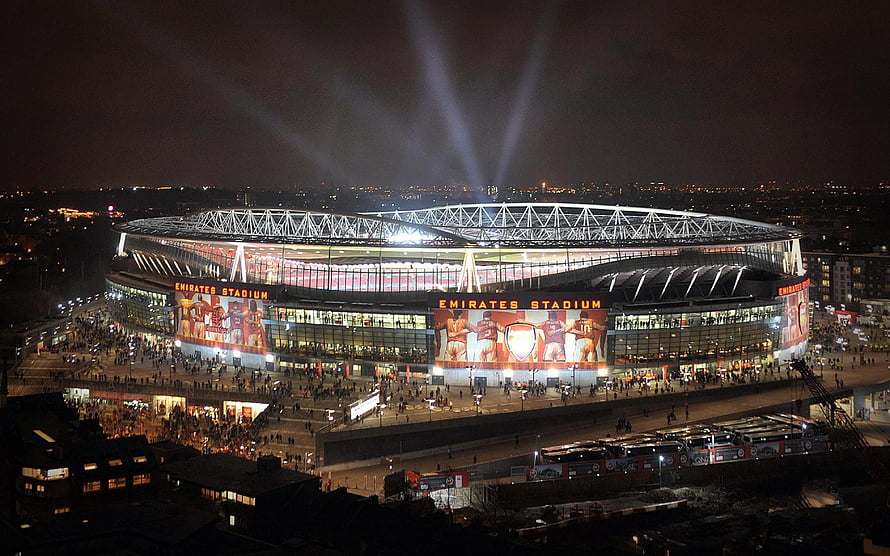 Emirates Stadium at Night with Arsenal Fans and Searchlights HD wallpaper