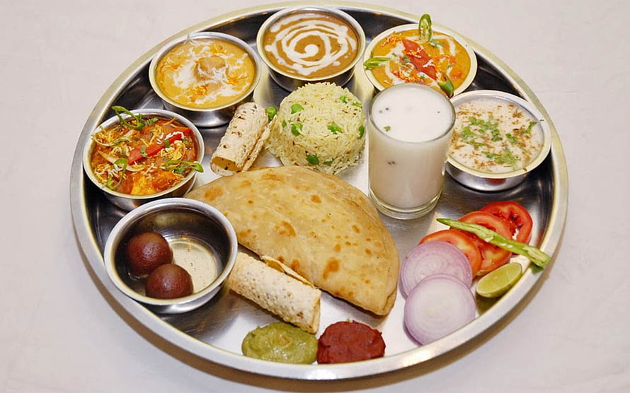 Traditional Punjabi Thali with Roti, Rice, Curries, and Lassi on a Steel Plate HD wallpaper