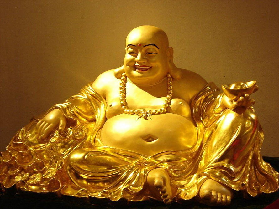 Golden Laughing Buddha Statue Holding Ingot and Coins HD wallpaper