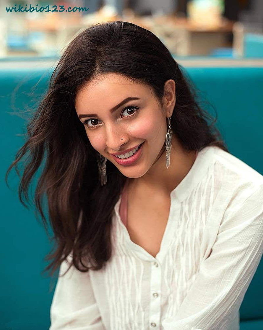 Tripti Dimri smiling portrait in white blouse with long dark hair and dangling earrings HD phone wallpaper