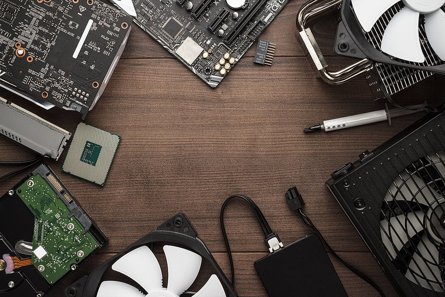 Computer Hardware Components and Repair Tools Arranged on a Wooden Workbench HD wallpaper