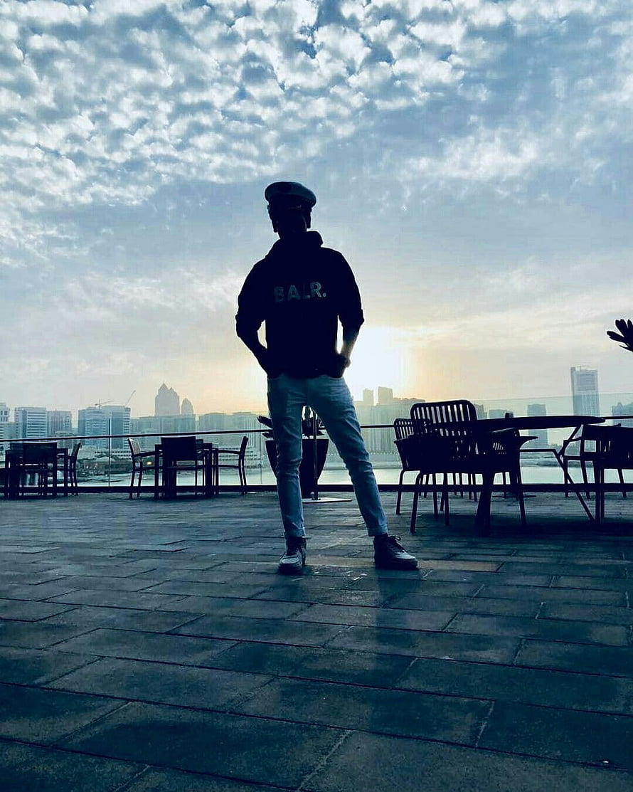 Silhouette of a man in a cap standing on a rooftop terrace overlooking a city skyline at sunset, Whatsapp DP in 2021, instagram dp boys HD phone wallpaper
