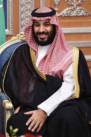 Mohammed bin Salman in Traditional Saudi Attire Seated on Ornate Throne HD phone wallpaper