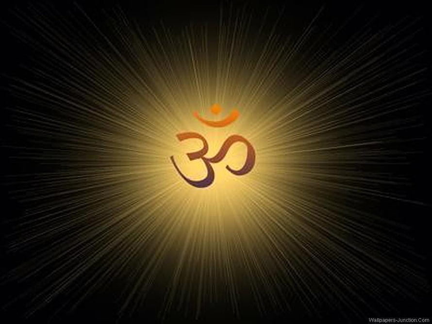 Glowing Om Symbol Radiating Golden Light on Dark Background HD wallpaper