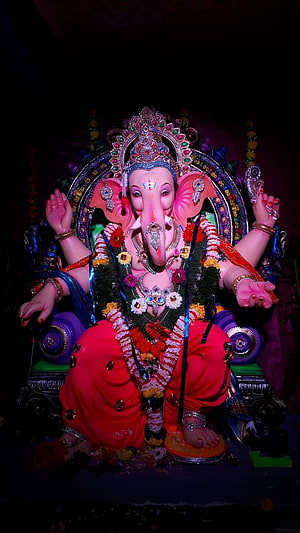 Ornate Ganesha Murti Adorned With Floral Garlands And Jewels In A Dark Temple Setting HD phone wallpaper