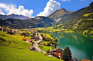 Lungern Switzerland Alpine Lake Village with Green Pastures and Mountain Peaks HD wallpaper